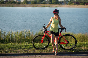 Woman on bike at the lake water background in the park