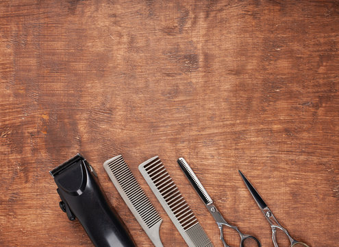Tools for cutting in hairdresser's haircuts on a dark background. A dangerous razor, a typewriter, a hair clipper.