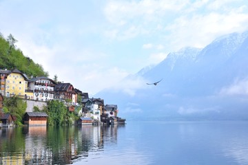 Fototapeta na wymiar Amazing Hallstatt village with beautiful lake and alps mountains on background. Unesco heritage. Austria landmark with historic cathedral and wooden houses on the lake. Romantic view 