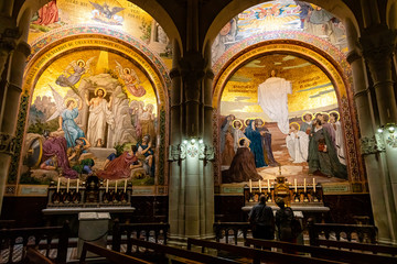 Fototapeta na wymiar Chapel inside the Rosary Basilica in Lourdes displaying Christian murals