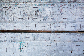 Steel background attached to concrete.