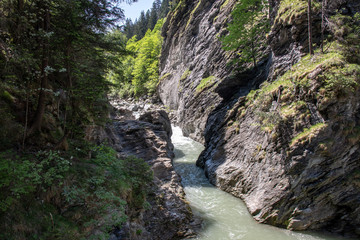 Obraz premium View of a wild river in a gorge in the Swiss Alps