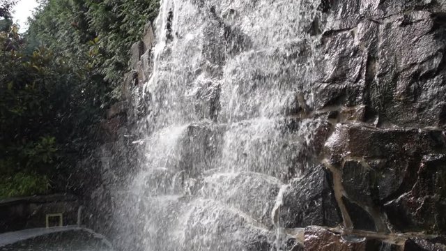 Water fall fountain tilt up slow motion
