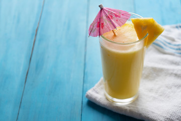 Pina colada cocktail with pink umbrella