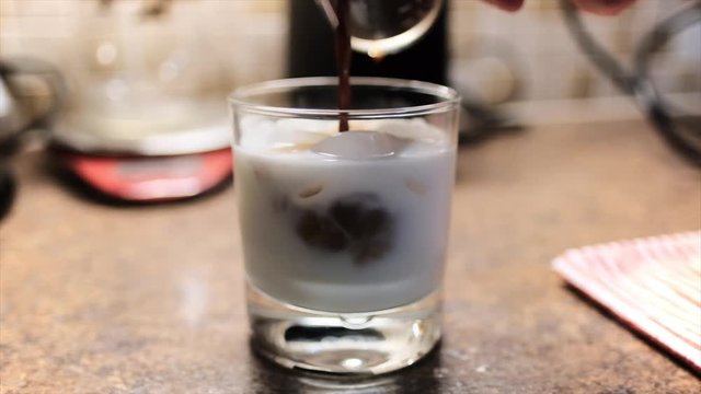 Detail of homemade iced coffee preparation. Static. Blurry. Slow motion