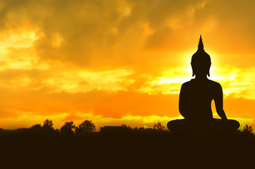 Asalha Puja Day concept , Silhouette largest Buddha image in the sunrise background in Thailand - Asia