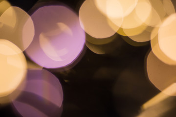 Christmas background, bokeh in dark colors, bokeh in purple and gold colors