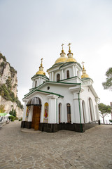 Golden Dome white church on the sky background