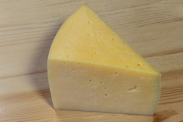 Slicing cheese on a cutting board.
