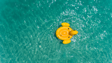 Top view from sky of duck swiming lifebuoy.