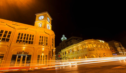 Fototapeta na wymiar Long exposure shot of an City streets with car trails and lights of Old Police Headquarters Chino-Portuguese Architecture in the background, in the city of 
