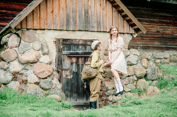 Happy woman hugging his husband came back from army. Smiling cheerful caucasian girlfriend embracing a soldier.