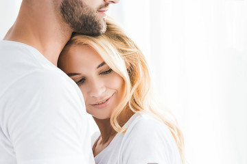 beautiful blonde woman leaning on bearded man with copy space