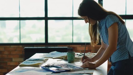 Inspired artist at work. Woman creating painting in studio workspace