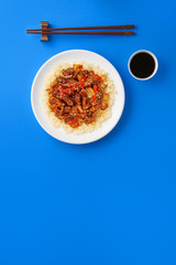 Sweet and Sour fried pork chunks with vegetables and rice. Top view with copy space
