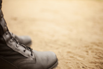 shoes on the beach. Boots on the sand. Bright background