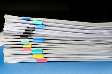Mock up, stack of papers documents in archives files with paper clips on desk at offices, business concept. Copy space.