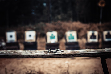 homemade shooting range in the open air with cartridge cases in the foreground