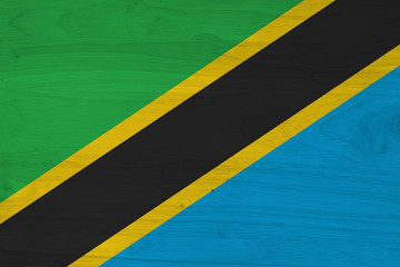 A rustic old Tanzania flag on weathered wood