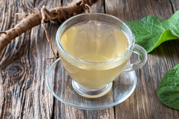 A cup of burdock tea on a table