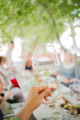 Wedding table setting. Festive table with white tablecloth. guests sit at the table. on the table are fruits, cheeses, glasses. cheese and wine tasting