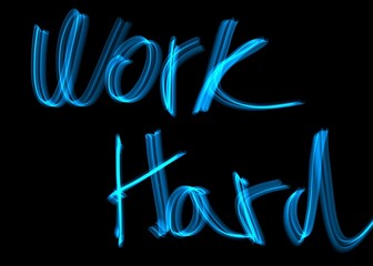 Blue neon style text work hard on black background