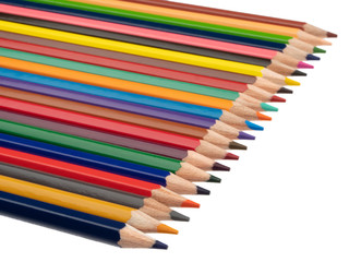 Lying colored pencils on the diagonal. On a white background. Still life. Close-up.
