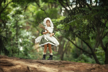 Magic childhood. Miracles happen. A little fairy girl walks through an incredibly beautiful green...