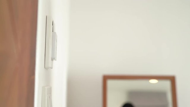 Hand using keycard open lighting in hotel room after check-in for resting relax travel lifestyle.