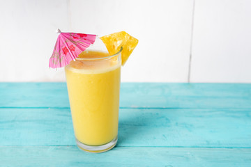 Pina colada cocktail with pink umbrella