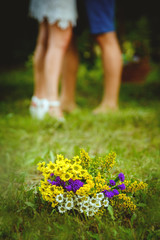 couple running in the park. Love story of two young people. Flowers on the grass.