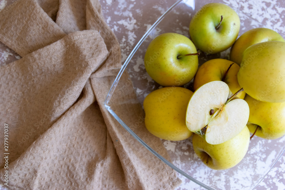 Wall mural apples on a plate on the table in the kitchen. Chantecler apples.