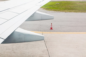 Wing of aircraft is flying,Is landing at Phuket International Airport Thailand.