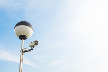 Security CCTV camera or surveillance system in background of outdoor area blue sky background,Tropical zone,In the Tourist port at Phuket Thailand.
