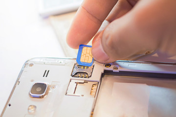Employees are putting nano SIM cards in the store for customers to buy,Men's hands, changing the...