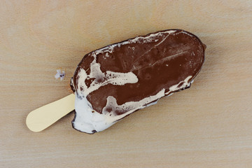 ice cream on a shelf, lies on a wooden background