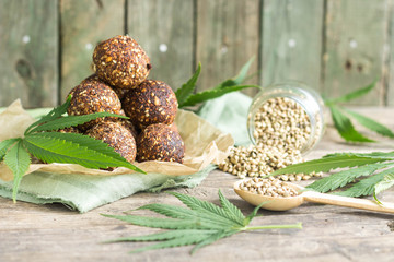 appetizing energy balls and canabis seeds and green leaves