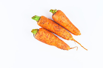 Three fresh carrot isolated on white background. The view from the top. Organic food background.