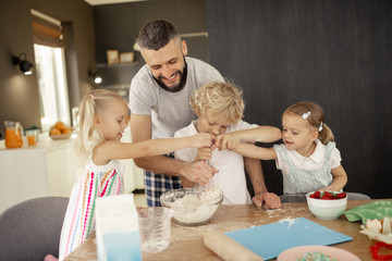 Nice active children wanting to hold a whisk