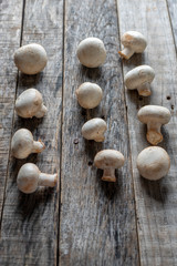 Champignon mushrooms on wooden background