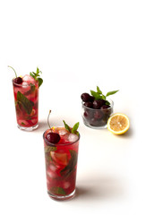 İced mint water with fresh cherry isolated on white background. Diet.