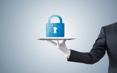 Businessman offering computer security on silver tray