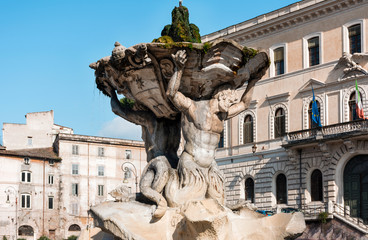 stone fountain in Rome on the background of old buildings on a Sunny day
