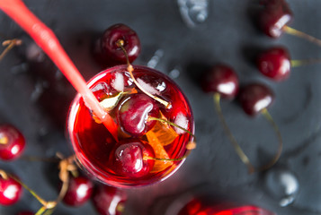 cherry, limonada glass of cherry on a black background, berries