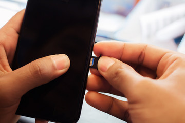 Employees are putting nano SIM cards in the store for customers to buy.