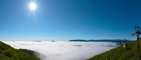 Panorama view from Unkai Terrace in summer time sunny day. Take the cable car at Tomamu Hoshino Resort, going up to see the sea of clouds. Shimukappu village, Hokkaido, Japan