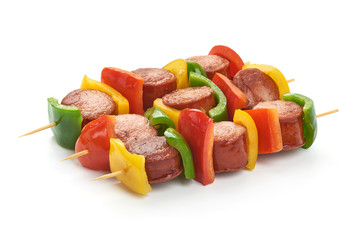 Shish Kebab - grilled pork bratwurst sausage skewers and vegetables BBQ, close-up, isolated on white background