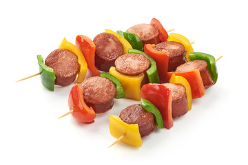 Shish Kebab - grilled pork bratwurst sausage skewers and vegetables BBQ, close-up, isolated on...