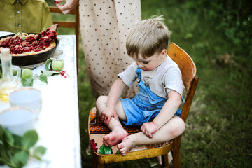 Child eating sweet pie in yard