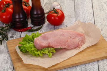 Raw Turkey steak served rosemary